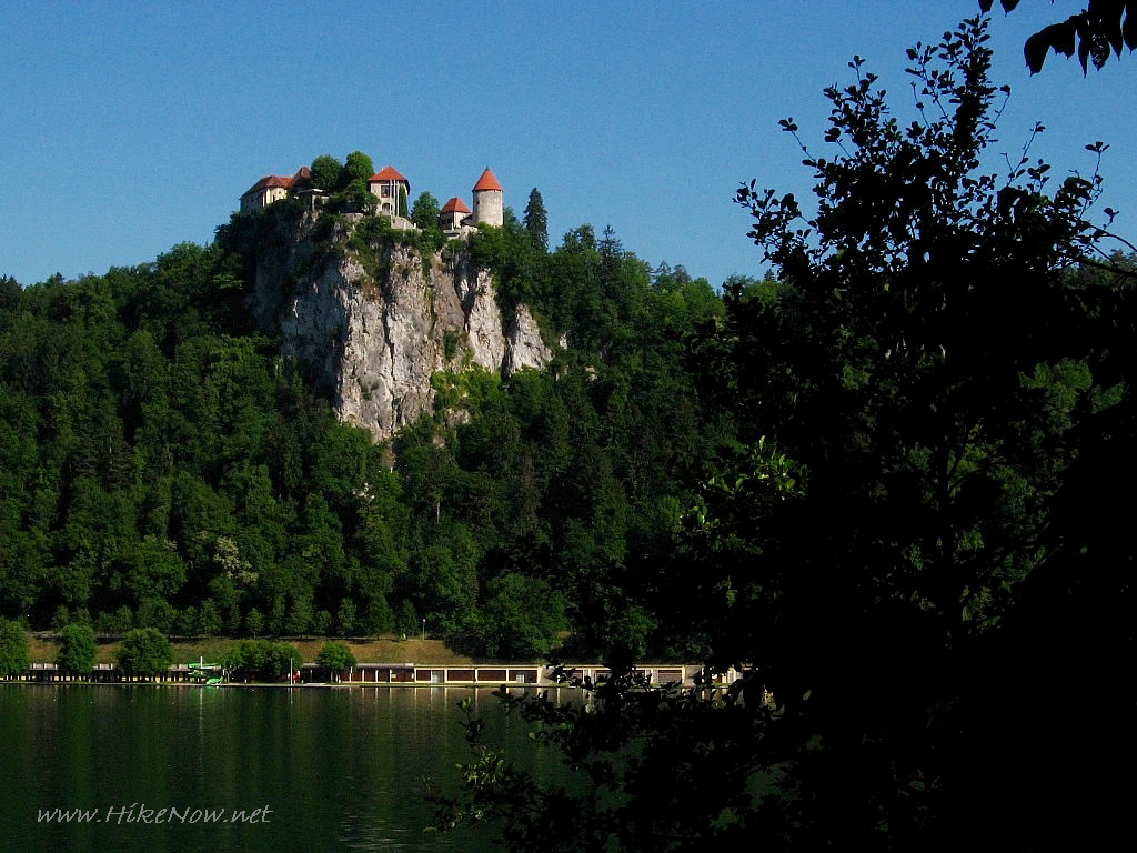 Walk to promenade around lake with a view to the castle on the cliff above Lake Bled - Slovenia 