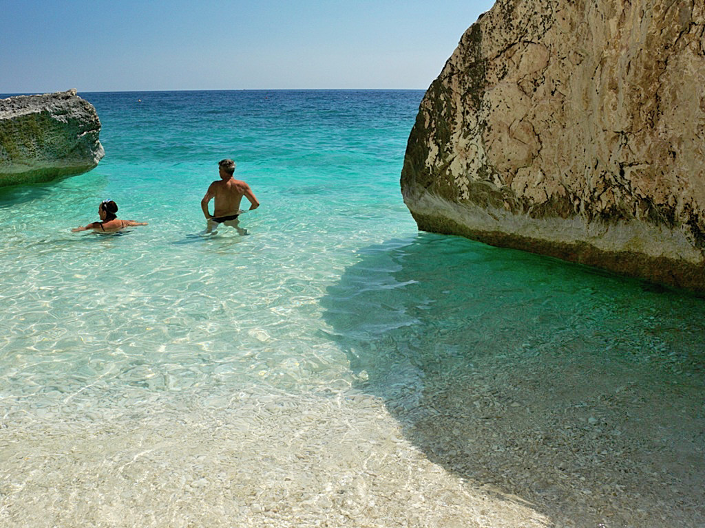 Bathing in crystal clear waters on holidays in Orosei gulf, Cala Mariolu - Sardinia Italy 