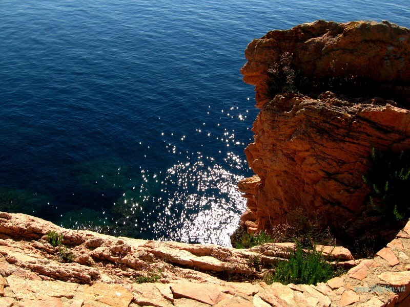 Pink cliffs above sparkling sea of Costa Brava, Spain
