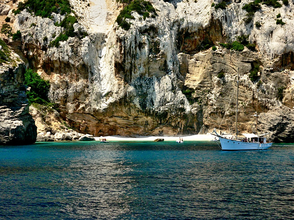 Golfo di Orosei or Orosei Gulf is perhaps the most spectacular gulf on the whole Sardinia, framed by towering cliffs, indented with coves, clear, emerald green waters lap long and sandy beaches - Sardinia