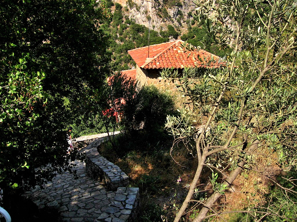 Idyllic place of New Philosophou monastery on a cliff above Lousios Gorge in the middle of greenery - Peloponnese Greece 