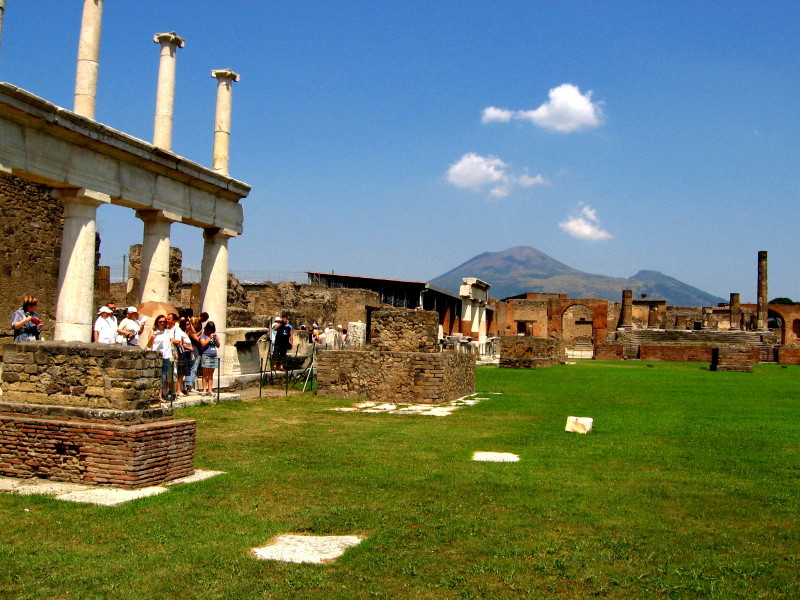 Strolling along ancient Pompeii with volcano Vesuvius in background - Italy 