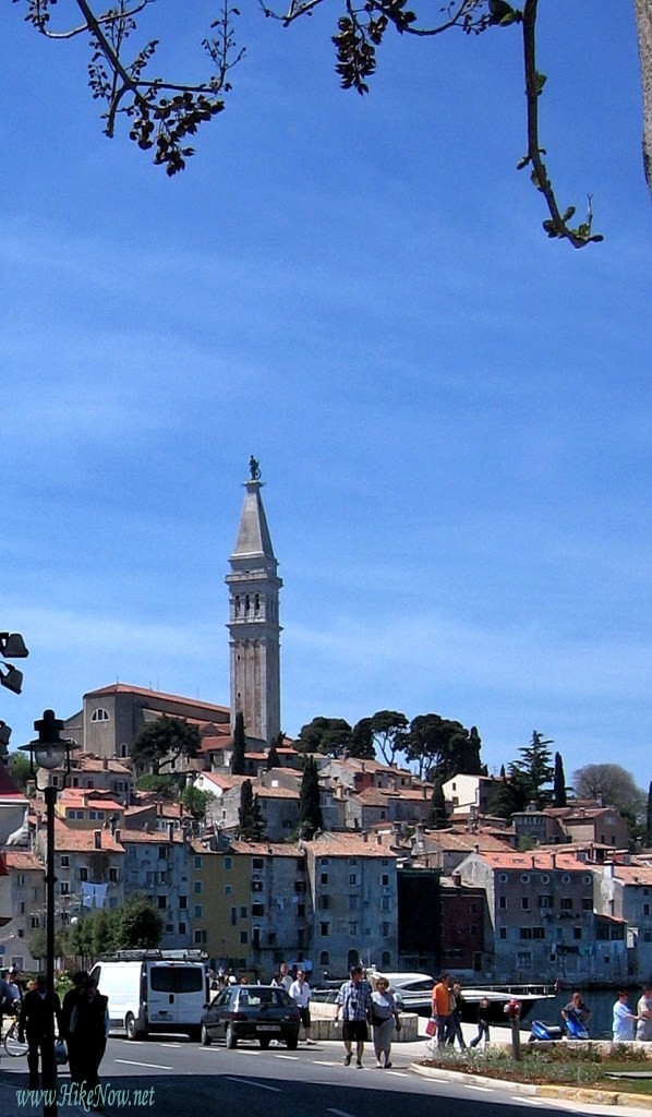 The bell tower of St. Euphemija in Rovinj welcoming the boats arriving in the port - Croatia 